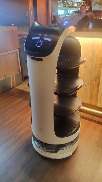 Robotic waiter with cat ears and kitty face on its screen