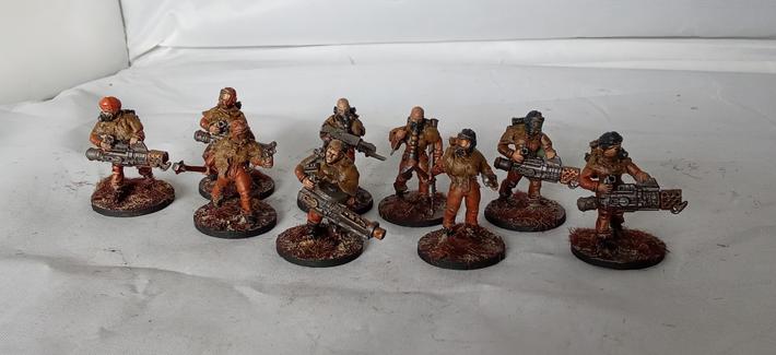 9 assorted models in orange jumpsuits, gasmasks and rags.