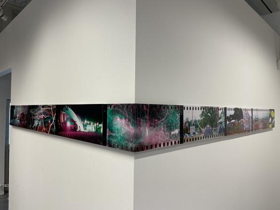 Panoramic photos on two walls as constant line one next to another. The solid line wraps around the corner, where one photo is bent at 90deg angle.