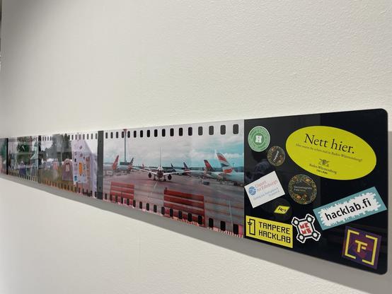 End of the photo stripe. The last piece has empty space which has stickers from multiple makerspaces given to me at the event, as well as hacklab.fi, Tampere hacklab, EMF stickers and the classic "Nett hier" of Baden-Württemberg
