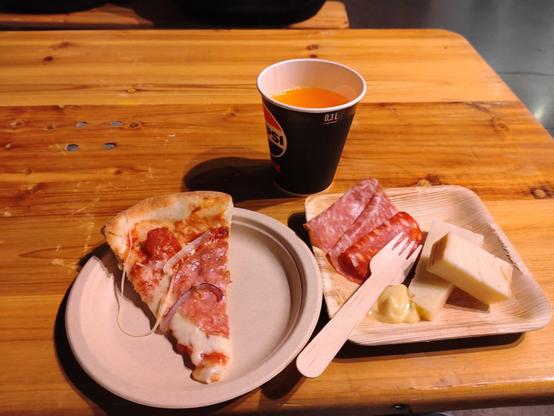 Italian food at JavaZone 2024 Pizza picante and a plate of Antipasti, Italian charcuterie and cheeses, olives, apricot chutney and grissini
