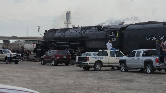 View showing scale of engine compared to engineer hanging out the window. It's 3 times taller than he is