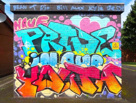 wild-style graffiti of the words "Have pride in our youth" on the wall of an electrical sub-station