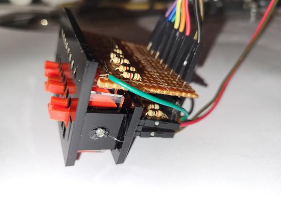 8 leds and 8 red plastic toggle switches in a line, black plastic frame and vero/resistors and connectors on the right.