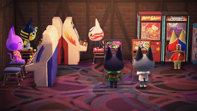 Animal Crossing: New Horizons screenshot. Set in an arcade with Ankha, Bob, Raymond, Stinky, Kabuki, and Kiki all playing arcade games. All the islanders in the arcade are cats.