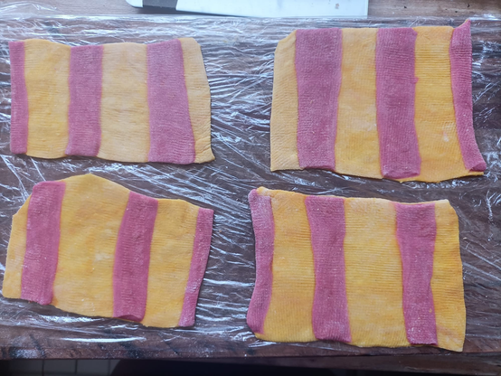 vier Nudelplatten mit gelben und roten Streifen