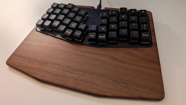 A photograph of the Keyboardio Atreus 44 key keyboard with the walnut palmrest.