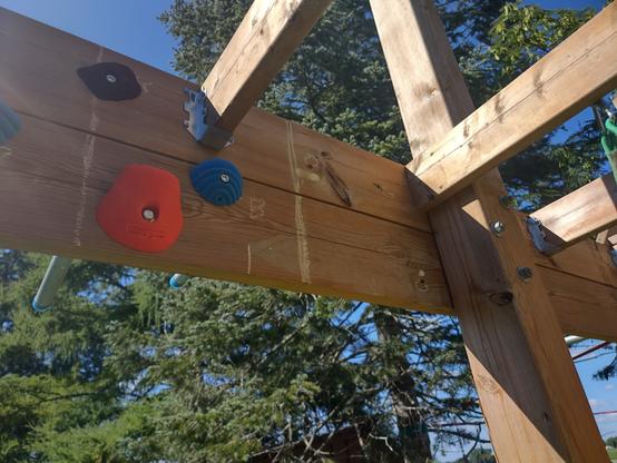 A spot that is missing 3 climbing holds. Their spots marked in chalk.