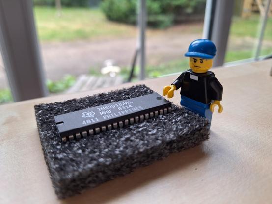 An anxious looking LEGO reverend standing by what is likely to be a fake IC from China