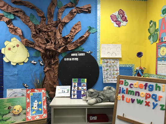 A kindergarten classroom with a magnetic alphabet board in the foreground. Photo by Monica Sedra via UnSplash.