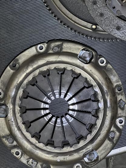 A Miata clutch pressure plate ruined by a destroyed throwout bearing.