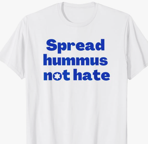 Spread hummus not hate is shown in blue lettering on a T shirt.