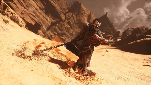 The same image, only zoomed out even further. In his hand, the character holds a large, ornately carved staff, which leaves a trail deep in the sand. The background shows rocky cliffs under a dramatic, cloudy sky, giving the scene a dark and epic atmosphere.
