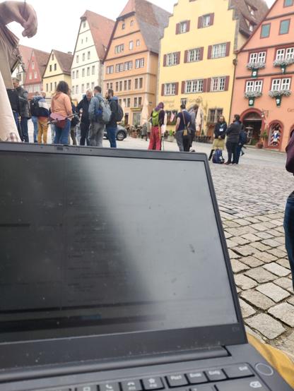 Picture of my laptop with in the background old medieval building with different colors