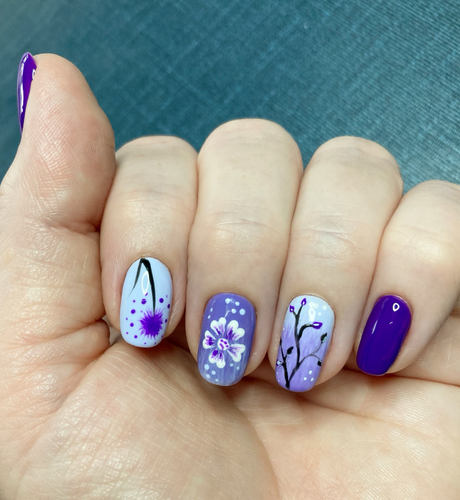 Nails with hand painted flowers in shades of lilac and purple