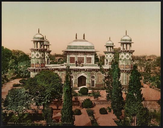 The image depicts a grand mausoleum with three towering minarets, situated in Agra, India. The structure is predominantly white and green, with intricate architectural details such as geometric patterns and domes at the tops of each minaret. The photograph has an old-fashioned appearance, likely due to its historical nature, which may be associated with the Photochrom process used by the Photoglob Company.

In front of the mausoleum is a lush garden with trees and lawns, adding to the serene setting. The overall ambiance suggests tranquility and reverence, typical of such sites dedicated to honoring and remembering important figures from history or religious beliefs.