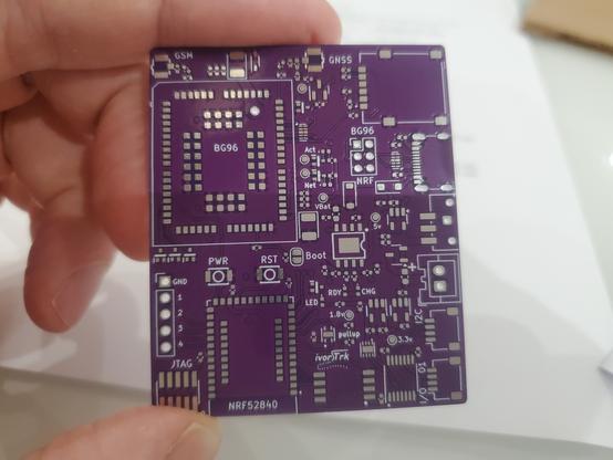 A purple circuit board held between finger and thumb