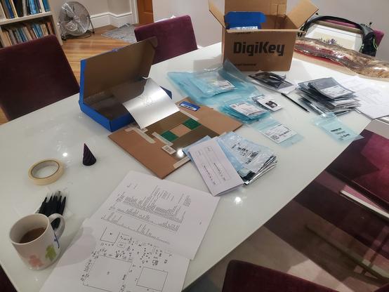 A dining table covered in components packets