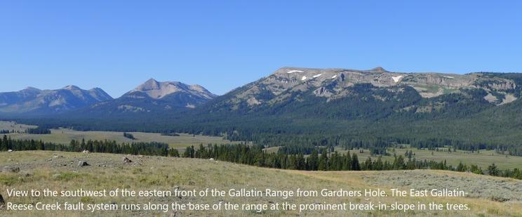 photo - View to the southwest of the eastern front of the Gallatin Range from Gardners Hole. The East Gallatin-Reese Creek fault system runs along the base of the range at the prominent break-in-slope in the trees.