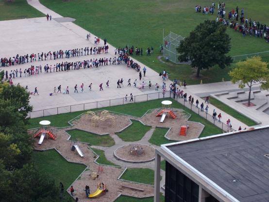children line up to start school and go inside for registration