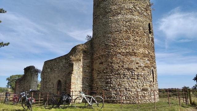 Bikes in front of a ruined round tower church