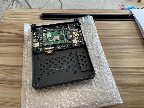 The inside of the console, partially assembled. A black metal enclosure holds several circuit boards and the CM4 module.