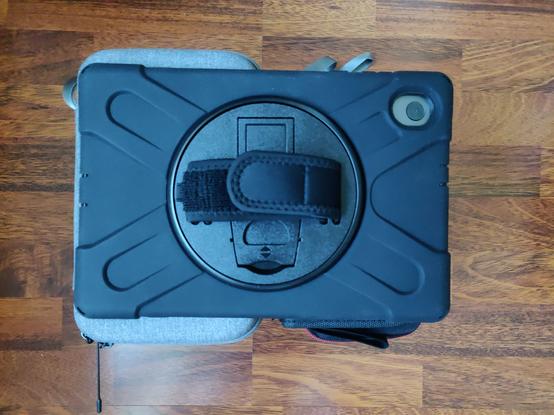 A tablet lies on small cases.