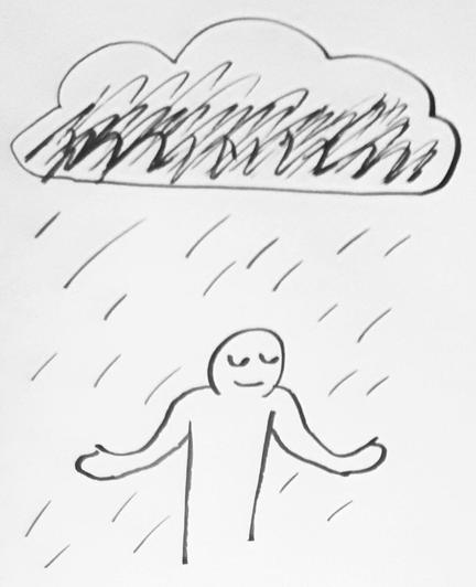 A man at peace, stands in the rain arms outstretched