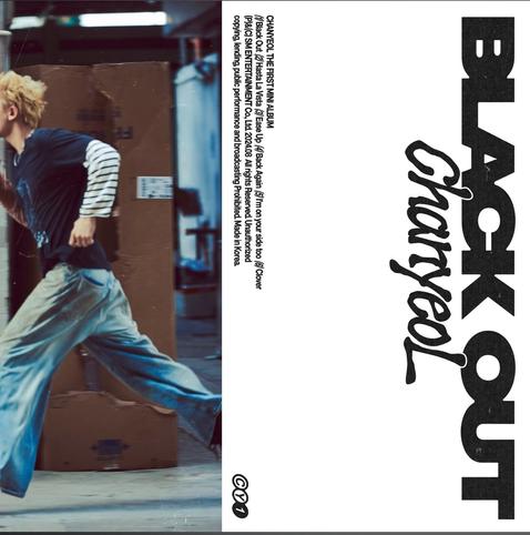 Album art for Chanyeol's solo album "Black Out." He is seen running down a city street in dirty jeans and blond hair.