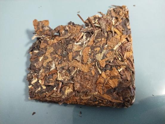 A chunk of white tea taken off of the brick.