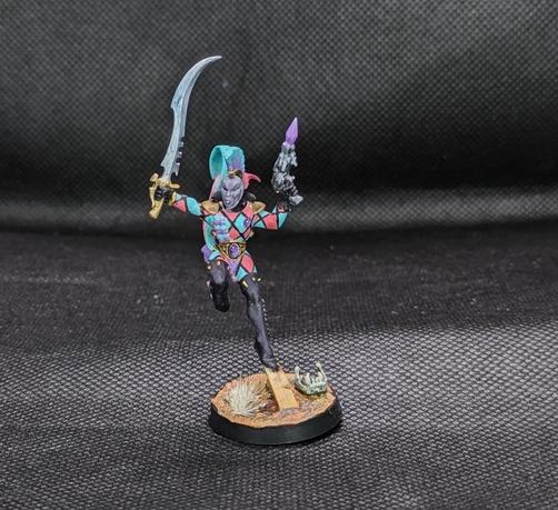 Harlequin miniature with a sword