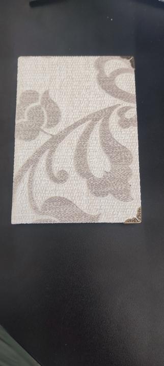 singl section hardcover booklet. Made using wallpaper. With some floral pattern on it.