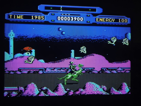 A gameplay snap on a crt TV under composite. A side-scrolling Defender clone with you riding left and right to generators under attack and waves of enemies coming in all the time.