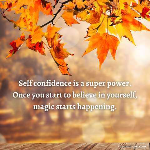 Orange and gold autumn leaves hanging low over a wooden picnic table in the foreground, a stand of trees in the distance. Over this are the words, "Self-confidence is a superpower. Once you start to believe in yourself, magic starts happening.”