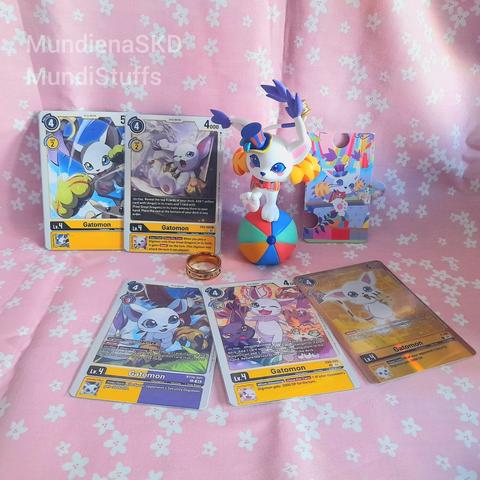 Circus Gatomon figure with some Gatomon cards from Digimon TCG and her Holy Ring.