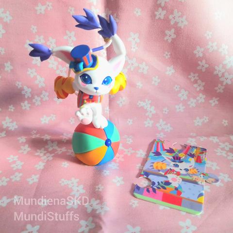 Circus Gatomon figure with her card in a pink with white cherry blossom background
