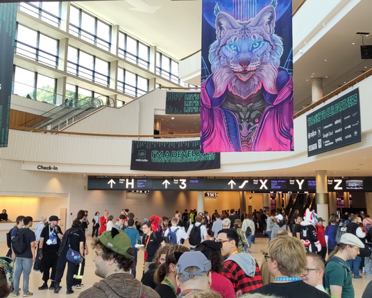 Entry hall of the CCH (convention centre Hamburg) with furries waiting in the queue for check in. A above a large furry banner in cyberpunk style, in the back an "I'm a developer, what's your superpower?" from code.talks.