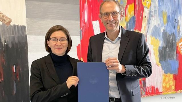 Prof. Dr. Sonja Kovacevic and Wiso-Dean Prof. Ulrich Thonemann, PhD, posing together while holding a document.