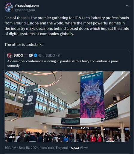 The image is a Twitter post by user "@seadragom" with the following text:

*"One of these is the premier gathering for IT & tech industry professionals from around Europe and the world, where the most powerful names in the industry make decisions behind closed doors which impact the state of digital systems at companies globally.

The other is code.talks."*

This is followed by a tweet from another user "@furSUDO" which reads:

"A developer conference running in parallel with a furry convention is pure comedy."

Below this is an image of the event venue. In the background, two banners are visible: one for "code.talks" (a tech conference) and another with an anthropomorphic blue and purple cat for "Eurofurence" (a furry convention). People are seen walking around the lobby, attending the events.