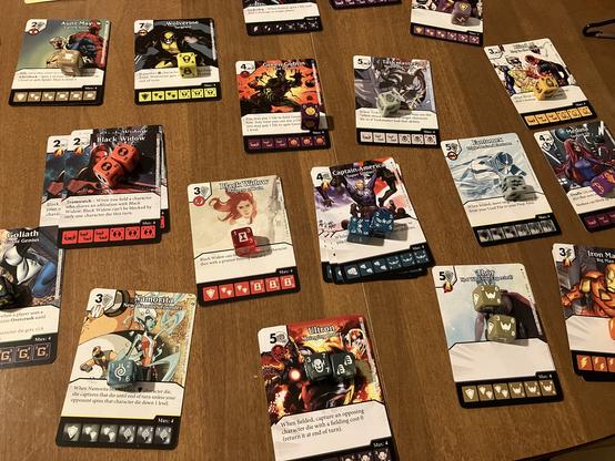 Game pieces for a dice game called Dice Masters - various cards shown have dice on top of them - the theme is Age of Ultron
