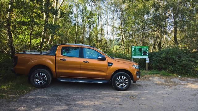 The #PrideOrange #WarMachine #SitsComfortably in front of some #RedundantSignage