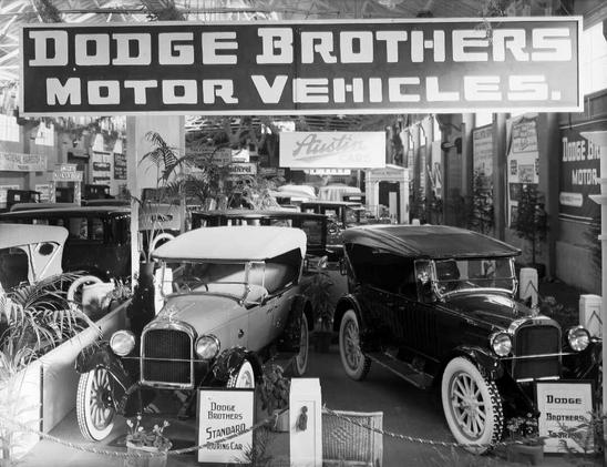 Black-and-white photo: Dodge motor cars at the Olympia Motor Show in Wellington. 1924. Photographer, Sydney Charles Smith. Description: Two Dodge motor cars on display at the Olympia Motor Show in Wellington. Citation: Smith, Sydney Charles, 1888-1972: Photographs of New Zealand. Ref: 1/1-020397-G. Alexander Turnbull Library, Wellington, New Zealand. https://natlib.govt.nz/records/22316058