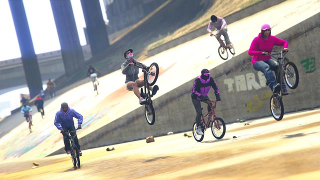 A screenshot I took in the video game GTA Online using the Rockstar Editor. It shows members of the crew BONK riding their BMXs doing funny stunts together.
