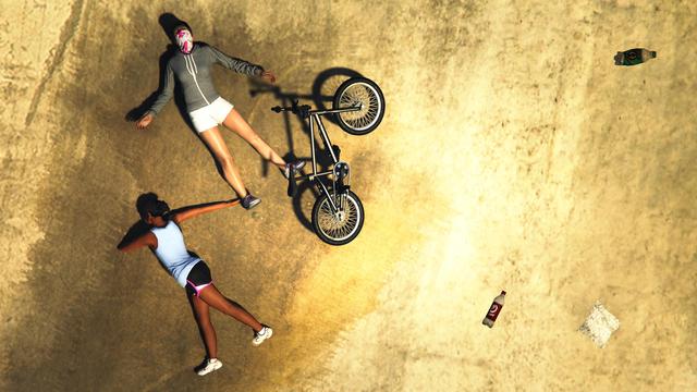 A screenshot I took in the video game GTA Online using the Rockstar Editor. It shows my female character with her BMX laying next to an NPC after a crash.