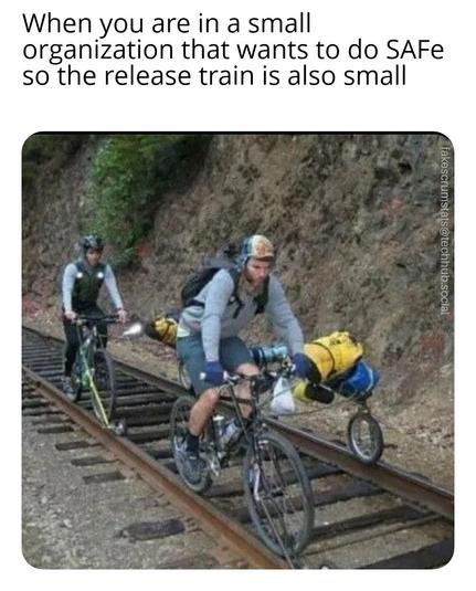 Photo of two men on bicycles riding train rails attached to a smaller bike also attached to the rail which holds some supplies.

Caption: When you are in a small organization that wants to do SAFe so the release train is also small