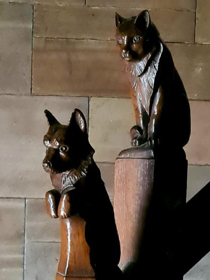 Two animal sculptures on the bannister of Glasgow's Mercat Cross.