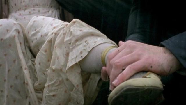 Two people, a man and a woman, in Georgian English clothing. The man is gently caressing the woman’s ankle, checking for broken bones.