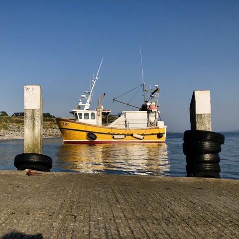 Fishing boat by a slip,Fenit Co. Kerry, blue sky