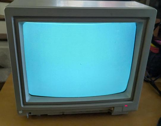 A 4x3 14" CRT Monitor with a lit screen and a red LED at the lower right.