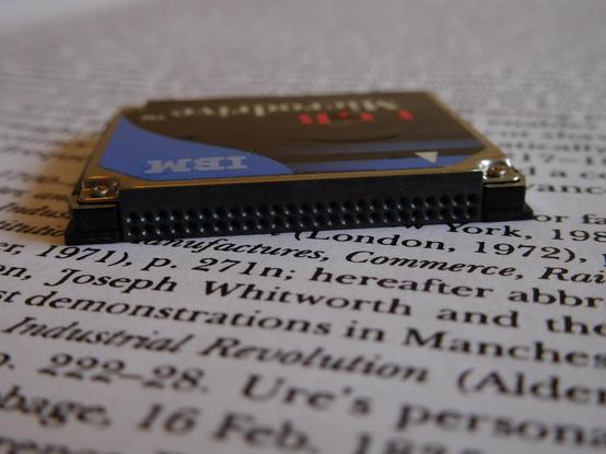 A close-up, edge-on view of the Microdrive, showing the Compact Flash connector. The edge-on angle shows that the drive is thicker than typical.